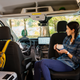 A woman sitting inside a Ford Transit Trail modified for use as an RV